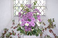 Some mauve and white dahlias decorate the church.